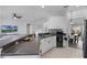 Open kitchen area with a breakfast bar, wine cooler, and views into an adjacent living space at 3643 Weatherfield Dr, Kissimmee, FL 34746