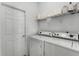 Laundry room featuring a washer and dryer along with a wire rack for storage at 3643 Weatherfield Dr, Kissimmee, FL 34746