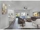 Modern living area features a ceiling fan, neutral decor, and sliding glass doors to the patio at 3643 Weatherfield Dr, Kissimmee, FL 34746