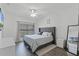 Well-lit bedroom with modern decor, wood-look floors, and a neutral color scheme at 3643 Weatherfield Dr, Kissimmee, FL 34746