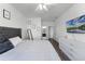 Bright bedroom with wood-look floors, modern decor, and an en-suite bathroom at 3643 Weatherfield Dr, Kissimmee, FL 34746