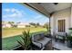 Relaxing screened patio with comfortable seating overlooking a lush green lawn and beautiful landscaping at 3643 Weatherfield Dr, Kissimmee, FL 34746