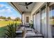 Relaxing screened patio with comfortable seating overlooking a lush green lawn and beautiful landscaping at 3643 Weatherfield Dr, Kissimmee, FL 34746