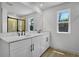 Modern bathroom features double vanities, quartz countertops and a glass enclosed shower with natural light at 3724 Deer Ridge Dr, Mount Dora, FL 32757