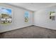 Bright bedroom with neutral carpet and neighborhood views from large windows for ample natural light at 3724 Deer Ridge Dr, Mount Dora, FL 32757