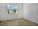 Bright empty bedroom with wood-look tile floors and a large window overlooking the neighborhood at 3724 Deer Ridge Dr, Mount Dora, FL 32757