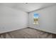Bedroom featuring neutral carpet and a window with tree-lined views at 3724 Deer Ridge Dr, Mount Dora, FL 32757