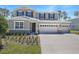 Charming two-story home showcasing stone accents, three-car garage and well-manicured lawn at 3724 Deer Ridge Dr, Mount Dora, FL 32757