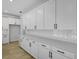 Bright kitchen featuring white cabinetry, countertops, and stainless steel appliances for a sleek look at 3724 Deer Ridge Dr, Mount Dora, FL 32757