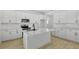 Modern kitchen with white cabinetry, an island with a sink, and stainless steel appliances at 3724 Deer Ridge Dr, Mount Dora, FL 32757