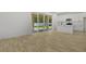 Spacious living room with access to patio, modern kitchen, and stylish wood-look tile floors at 3724 Deer Ridge Dr, Mount Dora, FL 32757
