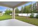 Covered porch with a view of a green backyard and white fencing at 3732 Deer Ridge Dr, Mount Dora, FL 32757