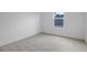 An empty bedroom with neutral carpet and a window at 3732 Deer Ridge Dr, Mount Dora, FL 32757