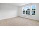 Bright bedroom featuring three large windows and neutral carpeting at 3732 Deer Ridge Dr, Mount Dora, FL 32757