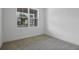 Cozy bedroom with plush carpeting and view of backyard at 3732 Deer Ridge Dr, Mount Dora, FL 32757