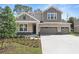 Charming two-story home with a two-car garage, landscaped yard, and manicured lawn at 3732 Deer Ridge Dr, Mount Dora, FL 32757