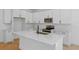 Bright kitchen featuring white cabinets, stainless steel appliances, and a spacious island at 3732 Deer Ridge Dr, Mount Dora, FL 32757