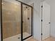 A tiled shower with a frameless glass door and modern fixtures at 3732 Deer Ridge Dr, Mount Dora, FL 32757
