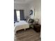 Bright bedroom boasting hardwood floors, large windows, and stylish decor at 7510 Seven Eagles Way # 7510, Reunion, FL 34747