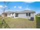 Backyard featuring a covered patio, grass, and the exterior of the home at 652 Hennepin Loop, Lake Wales, FL 33898