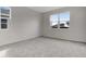 Bright bedroom with gray carpet, two windows offering natural light and neutral walls at 652 Hennepin Loop, Lake Wales, FL 33898