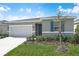 Charming one-story home with a well-maintained lawn, complemented by a clean, two-car garage at 652 Hennepin Loop, Lake Wales, FL 33898