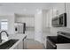 Bright kitchen featuring stainless steel appliances, an island with a sink, and white cabinetry at 652 Hennepin Loop, Lake Wales, FL 33898
