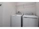 Laundry room equipped with modern washer and dryer units and wire shelving at 652 Hennepin Loop, Lake Wales, FL 33898