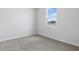 Clean, empty carpeted bedroom with a bright window at 656 Hennepin Loop, Lake Wales, FL 33898