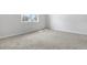 Bright bedroom featuring neutral walls, carpet flooring, and a window for natural light at 656 Hennepin Loop, Lake Wales, FL 33898