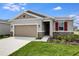 Charming single-story home with a two-car garage, stone accents, and a well-maintained lawn at 656 Hennepin Loop, Lake Wales, FL 33898