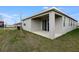 Exterior view of the home's covered patio and sliding glass doors overlooking the backyard at 656 Hennepin Loop, Lake Wales, FL 33898
