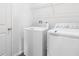 Functional laundry room with a washer, dryer, and wire shelving for convenient storage at 656 Hennepin Loop, Lake Wales, FL 33898