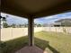 View of the backyard with green grass and white fence at 1222 Castlevecchio Loop, Orlando, FL 32825