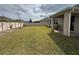 Manicured backyard featuring healthy lawn, fence, and covered patio at 1222 Castlevecchio Loop, Orlando, FL 32825