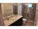 Bathroom featuring a double vanity sink, a walk-in shower with glass doors, and tile flooring at 1222 Castlevecchio Loop, Orlando, FL 32825