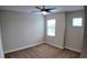 This bedroom has a ceiling fan, neutral paint, carpet, and natural light at 1222 Castlevecchio Loop, Orlando, FL 32825