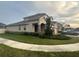 Well-maintained home with a manicured lawn, covered porch, and a two-car garage, in a friendly neighborhood at 1222 Castlevecchio Loop, Orlando, FL 32825