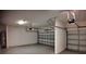 Spacious garage with two-car and one-car door, concrete walls, and overhead lighting at 1222 Castlevecchio Loop, Orlando, FL 32825