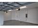 Spacious two-car garage with concrete block walls, overhead lights, and garage door openers at 1222 Castlevecchio Loop, Orlando, FL 32825