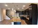 Modern kitchen features dark cabinetry, granite countertops, and an island with a sink at 1222 Castlevecchio Loop, Orlando, FL 32825