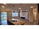 Bright open-concept living room with large windows, modern light fixture, and accent wall at 1222 Castlevecchio Loop, Orlando, FL 32825