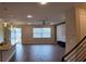 Open concept living space with wood floors, modern light fixtures, sliding doors, an accent wall, and metal staircase railings at 1222 Castlevecchio Loop, Orlando, FL 32825