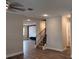 Well-lit living room featuring wood floors, recessed lighting, an accent wall, and a staircase with dark metal railings at 1222 Castlevecchio Loop, Orlando, FL 32825