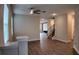 Open-concept living room with wood flooring, contemporary light fixtures, lots of light, and a view of the staircase and accent wall at 1222 Castlevecchio Loop, Orlando, FL 32825