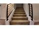Carpeted stairs with modern black railing at 1222 Castlevecchio Loop, Orlando, FL 32825