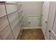 Organized walk-in closet featuring metal shelving, neutral paint, and access panel at 1222 Castlevecchio Loop, Orlando, FL 32825