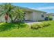 The backyard features a covered patio and lush green grass at 1569 Thetford Cir, Orlando, FL 32824