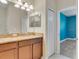 Bathroom boasts double vanity, granite countertops, and tile flooring leading to an adjacent bedroom at 1569 Thetford Cir, Orlando, FL 32824