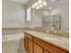 Bright bathroom featuring double vanity with granite countertops, soaking tub, and separate glass shower at 1569 Thetford Cir, Orlando, FL 32824